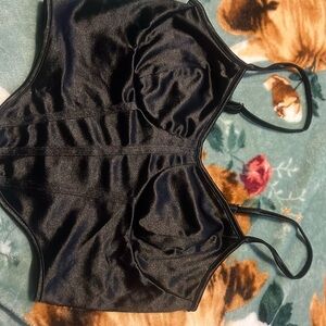 This is a black silk material tank top that looks like a corset. It’s a medium